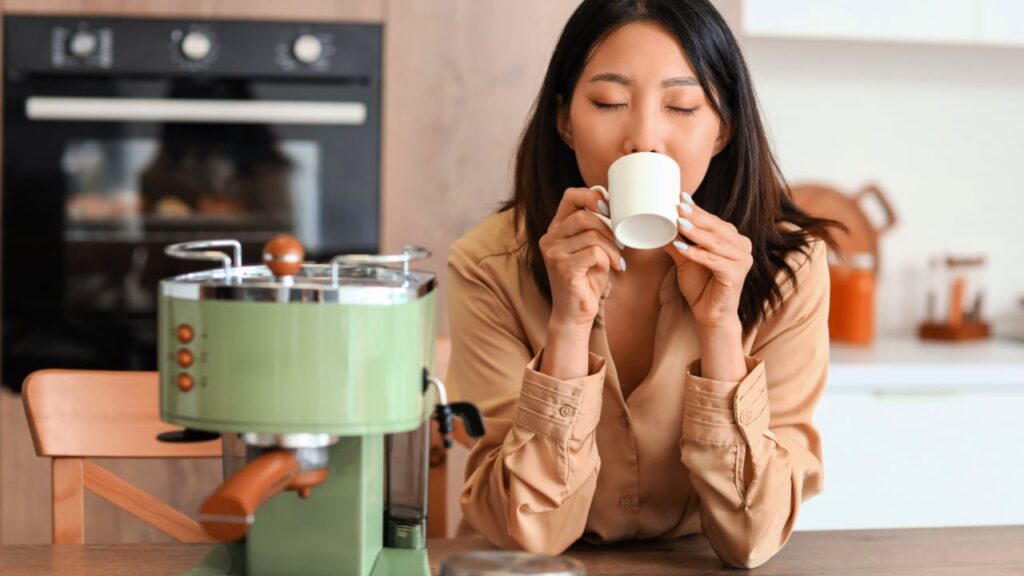 woman drinking hot coffee in kitchen